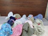 a bed with many hats on it in a room