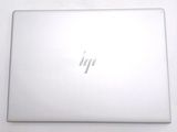 the back of a laptop computer sitting on top of a white table