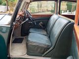 a green car with a black seat in the back