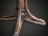 an image of a wooden table with a round top on a black background