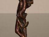 bronze statue of a man with a bird on his shoulder