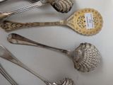a lot of silver spoons and spoon spoons on a table