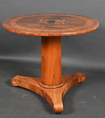 a wooden table with a round top and a wooden base
