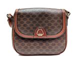 un sac à main marron et noir muni d'une poignée marron