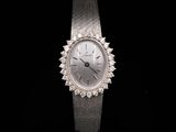 an image of a woman ' s wrist watch on a black background