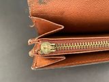 the inside of a brown purse with a zipper open