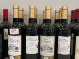 several bottles of wine are lined up on a counter