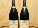 deux bouteilles de vin posées l'une à côté de l'autre sur un tonneau