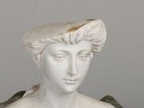 a statue of a woman with a hat on top of her head