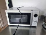 a microwave that is sitting on a counter with a blender