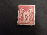 a close up of a red and white stamp on a black surface