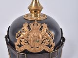 a black and gold helmet with a gold crown on it
