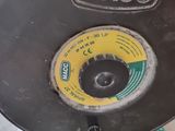 a black and yellow disc that is sitting on a table