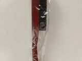 a black and red toothbrush in a plastic bag on a table