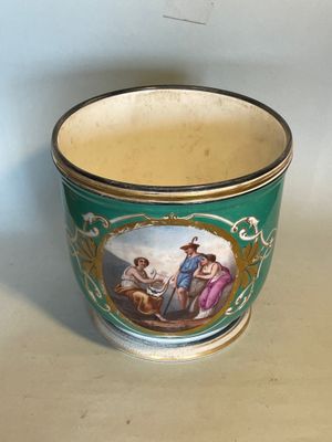 a green cup with a picture of a man and a woman on it