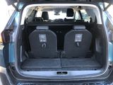 two seats in the back of a car with the doors open