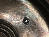 close up of a metal object with a small button on it