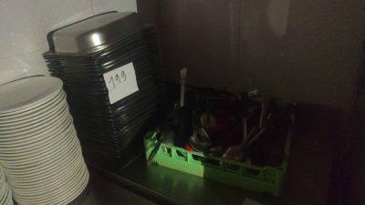 a stack of plates and cups sitting on a shelf