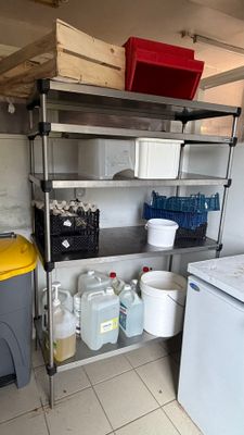 a kitchen with a washer, dryer, and refrigerator in it