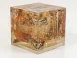 a small box with a painting on it on a white surface