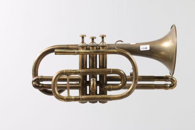 an old brass trumpet hanging from the ceiling