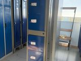 several blue lockers are lined up in a row in a hallway