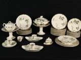 many plates and cups and saucers on the table