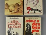 four books on a table with one of them in the middle