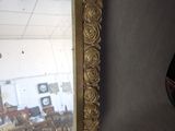a mirror hanging on the wall in a room