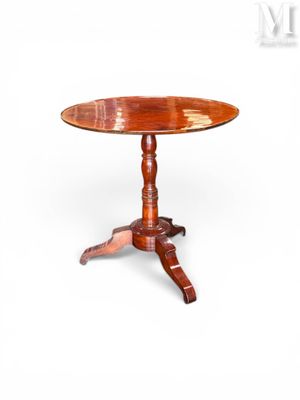 une table en bois avec un plateau circulaire et un piètement en bois