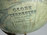 an old globe on a wooden stand with a map on it