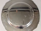a silver plate that is on a white table