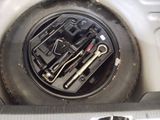a close up of a car ' s tire with a wrench in it