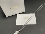 a white box with a silver necklace and a white box with a silver necklace
