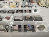 many different kinds of rocks in a display case