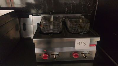two deep fryers sitting on the counter in the kitchen