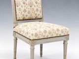 an upholstered chair with a floral upholstered seat