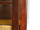 a wooden cabinet with a glass door and a curtain