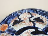 a blue and white plate with an oriental design on it