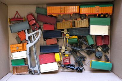 a cardboard box filled with toy trucks and other toys