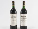two bottles of wine sitting next to each other on a white surface