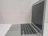 a silver laptop computer sitting on a white table