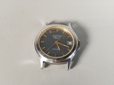 a silver watch with a black face on a white surface