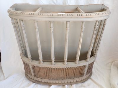 a white basket that is sitting on a white sheet