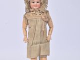 a small doll that is standing on a metal stand