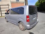 a silver van that is parked in a parking lot
