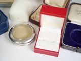 a small box with a ring inside of it on a table