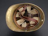 an old helmet with a leather band and a leather strap