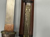 a knife hanging on the wall next to a knife holder