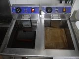 two deep fryers that are sitting in a kitchen